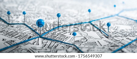 Routes with blue pins on a city map. Concept on the  adventure, discovery, navigation, communication, logistics, geography, transport and travel topics. Royalty-Free Stock Photo #1756549307