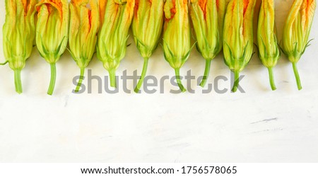 Zucchini flowers isolated on white background. Top view. Organic food.