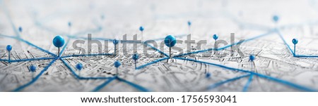 Location marking with a pin on a map with routes. Find your way. Adventure, discovery, navigation, communication, logistics, geography, transport and travel theme concept background. Royalty-Free Stock Photo #1756593041