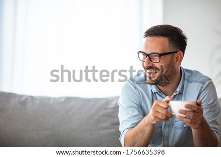 Cropped portrait of a handsome young man enjoying a cup of coffee in the morning. Portrait of a smiling businessman having a break. Coffee first then what to do for the day 