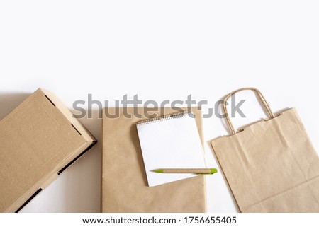 A lot of Craft Paper Bags and Boxes on the white Background. Concept of Delivery Service Packing Order for Customer.