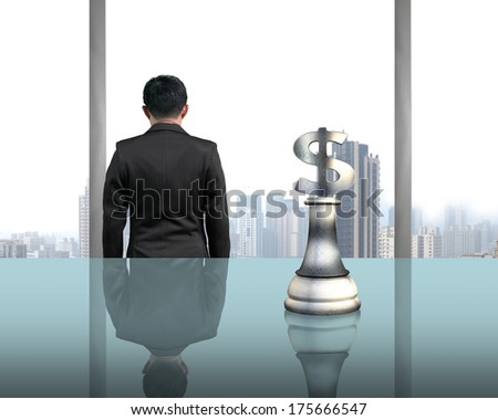 Rear view businessman with money symbol piece on table with city view