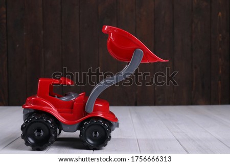 red toy excavator on a white background