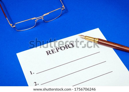 Report form on the office blue desk with glasses and pen, business idea