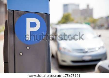 Blue parking sign with blurred cars at the background in New York City