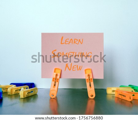 Multiple clamps hold lettering paper