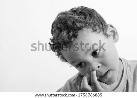 boy picking his nose with white background stock photo 