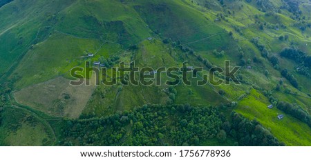 Spring landscape of mountains with meadows of mowing and pasiegas cabins or shepherd huts in Miera Valley in Cantabria Autonomous Community of Spain, Europe