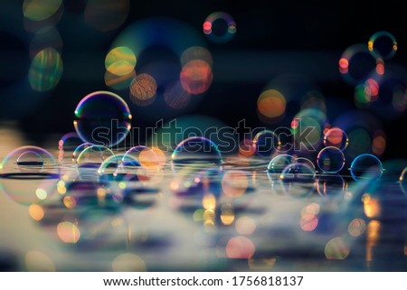 decorative fairy background with lots of shiny iridescent soap bubbles fly and are reflected in the rays of the sunset
