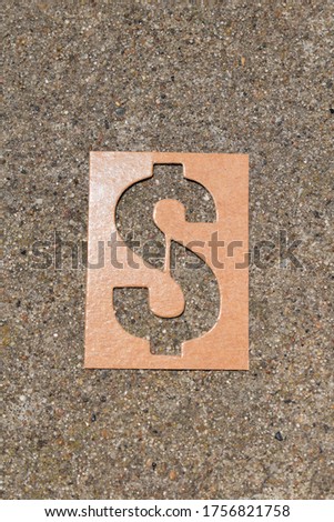 Cardboard dollar sign with cement background