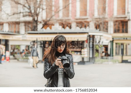 Female photographer taking photos in the city