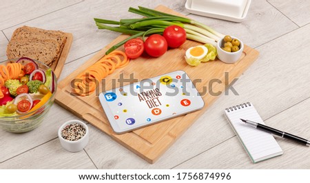 Healthy Tablet Pc compostion with ATKINS DIET inscription, weight loss concept Royalty-Free Stock Photo #1756874996