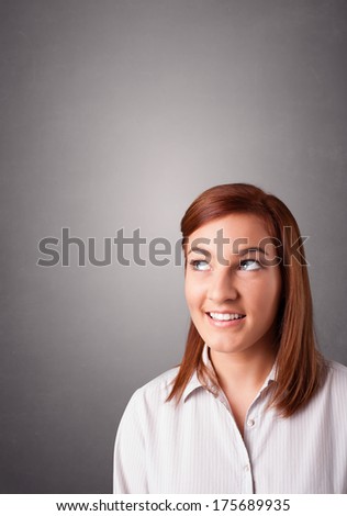 Beautiful young woman standing and thinking with copy space