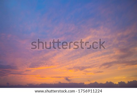 Pale lilac tinted clouds at sunset in tropical Broome, North Western Australia  are beautifully hued with soft pink and lavender tones as the hot sun sinks into the Indian Ocean in the summer Wet.
