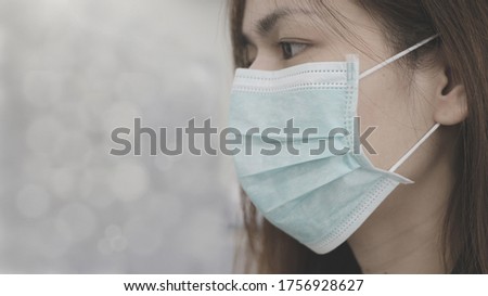 Wear face mask. woman is wearing protection face mask against coronavirus in gray tone picture. surgical mask covering face for  novel coronavirus proctection concept. rectangle size.