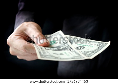 Hand of business man  he holds dollar usa give to help
