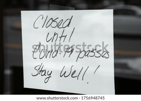 "Closed until Covid-19 passes. Stay Well!" sign on a storefront