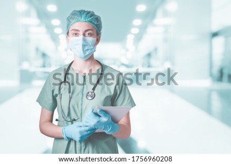 Medical Surgical Doctor and Health Care, Portrait of Surgeon Doctor in PPE Equipment in Examination Room. Medicine Female Doctors Wearing Face Mask and Cap for Patients Surgery Work. Medic Hospital Royalty-Free Stock Photo #1756960208