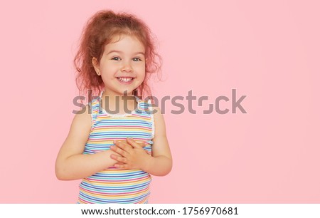 Portrait of cute little child girl with a snow-white smile and healthy teeth over pink background. looking at the camera and laughing. Dentistry for children Royalty-Free Stock Photo #1756970681