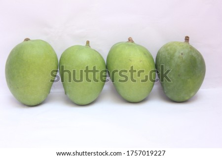 Unripe or Raw Mangoes on a White Background, Selective Focus