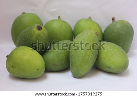 Unripe or Raw Mangoes on a White Background, Selective Focus