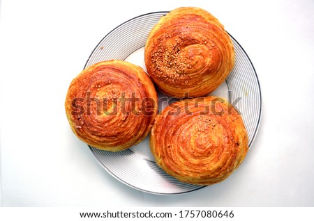 Fresh pastries Gogal isolated on white background. Gogal Traditional Azerbaijani Cookie on Novruz Easter . Novruz holiday with Azerbaijan national pastry Gogal and glass