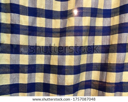 Blue and white square pattern of loincloth in waver moment. Traditional Thai’s classic fabric product. Concept of pattern textile.