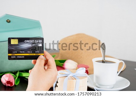 Women hand Using a black credit card, she pulled the card out of her wallet. Credit debit card with chip.