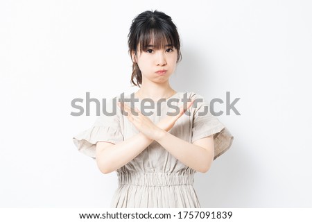 Young woman making an NG gesture shot in the studio