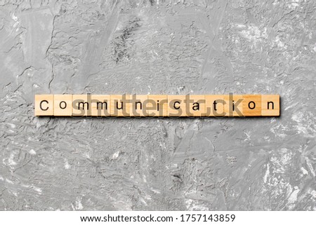 COMMUNICATION word written on wood block. COMMUNICATION text on cement table for your desing, concept.