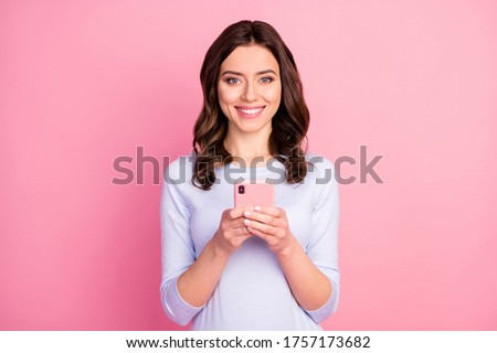 Photo of beautiful attractive lady curly hairdo hold telephone online freelance work quarantine stay home read news wear casual white sweater isolated pastel pink color background