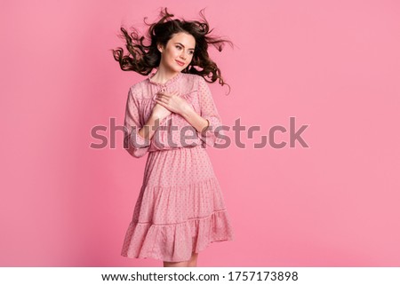 Photo of peaceful kind girl out hands chest look copyspace feel grateful hair wind blow wear dotted dress skirt isolated over pastel color background