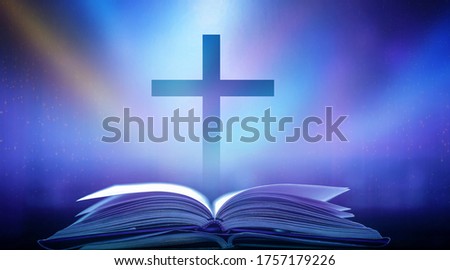 The Christian Cross is illuminated in a book in white and fantasy light, with magic shining as hope, love and freedom in beautiful illustrations.