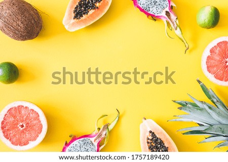 Summer fruits. Tropical fruits on yellow background. Summer concept. Flat lay, top view, copy space