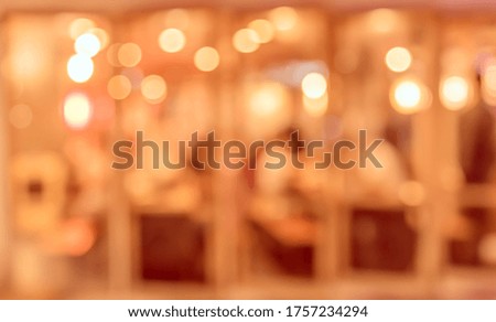 Vintage tone abstract blur image of Restaurant or Cafe in night time with bokeh for background usage .