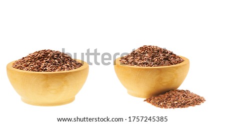 flaxseed in a small wooden bowl  isolated on a white background. Two servings of flax seeds. Royalty-Free Stock Photo #1757245385