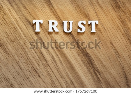 Trust word on wooden surface