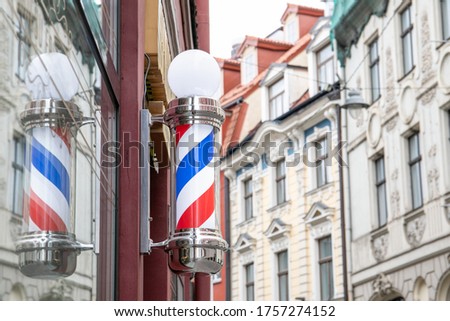 A barber's pole - sign used by barbers to signify the place or shop where they perform their craft. City view