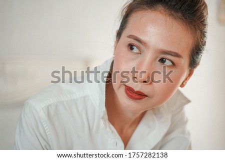Close-up portrait of beautiful woman in white shirt