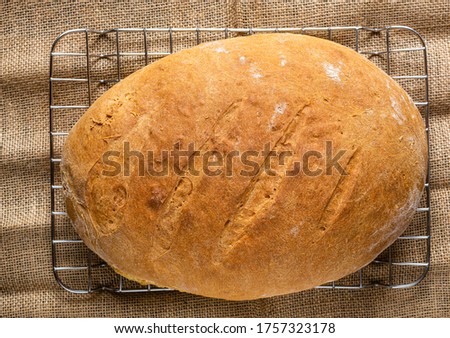 Homemade bread. Photo from above. Homemade pastries. Made from wheat flour. Tasty and healthy. Fresh bread on the kitchen table. For vegetarians.