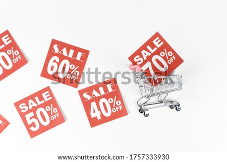 Shopping Sale - 40%, 50%, 60%, 70% Discount with Shopping Cart isolated on white background side view