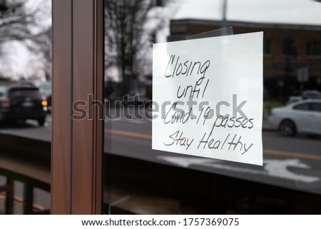 "Closed until Covid-19 passes. Stay healthy!" sign in a storefront window