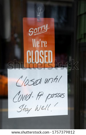 "Closed until Covid-19 passes. Stay Well!" sign in a storefront window