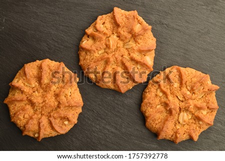 Sweet, tasty, grain cookies, close-up, on a serving plate of slate.