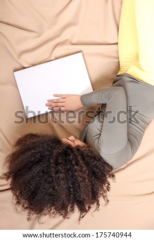 A young adult woman with a Laptop.