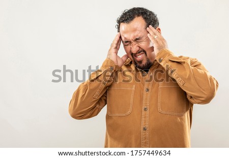 expression and people concept - Man with headache over gray background. Adult over 40 years of age.