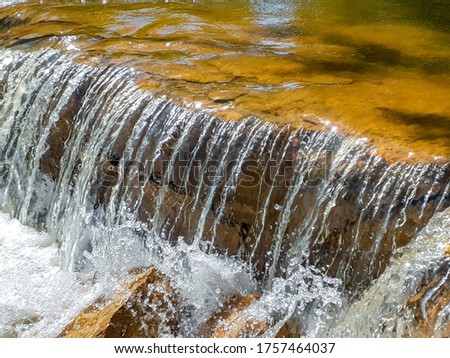A small waterfall in a big flowing river in Kansas 