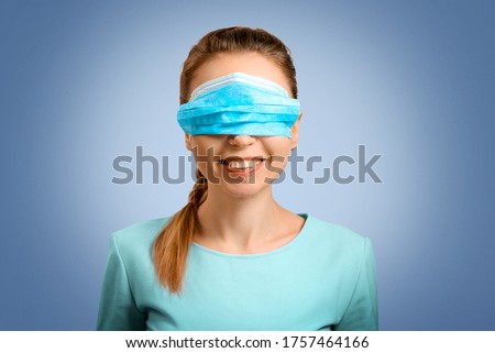 The girl incorrectly put on a protective mask. The nurse teaches you to put on a mask. Protection from disease and virus. Disposable mask. Self-isolation protection. The woman doctor smiles. Royalty-Free Stock Photo #1757464166