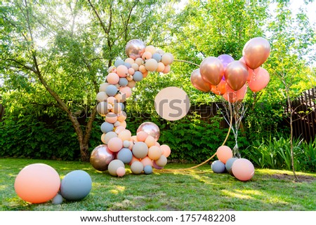 Photozone holiday with balloons on the background of greenery in the garden in the backyard Royalty-Free Stock Photo #1757482208