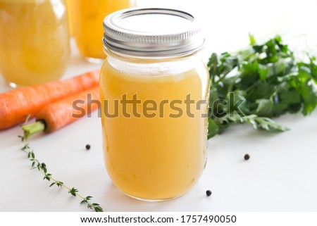Homemade chicken stock in glass jar